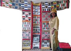 Artist Madona Cole-Lacy in her showroom with newly designed Coat of Many Cultures